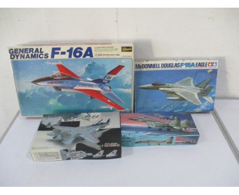 A collection of four boxed fighter jet model kits including Hasegawa, Tamiya, Fujumi etc
