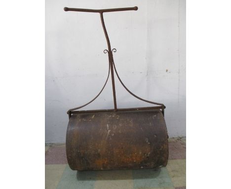A large Victorian garden roller with decorative cast iron ends 