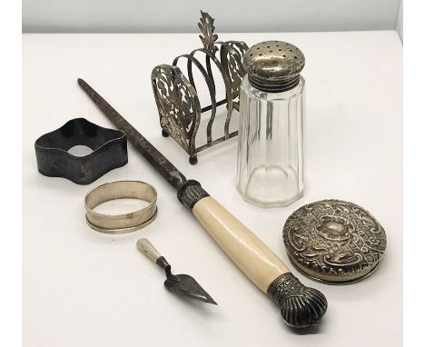 A hallmarked silver bookmark in the form of a trowel, silver lidded sugar caster, silver lid along with an Eastern SCM toastr