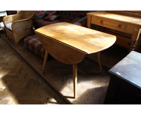 A mid Century Ercol beech and elm drop leaf dining table