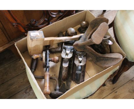 A box of various woodworking tools including planes