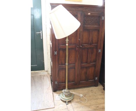 An Edwardian brass standard lamp on paw feet