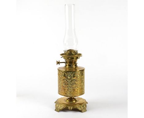 A Victorian brass oil lamp,  with floral design, height 30cm, with glass chimney, 