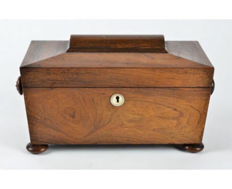 A Victorian rosewood tea caddy, sarcophagus shaped, the hinged lid opening to reveal two lidded sections and an empty space f