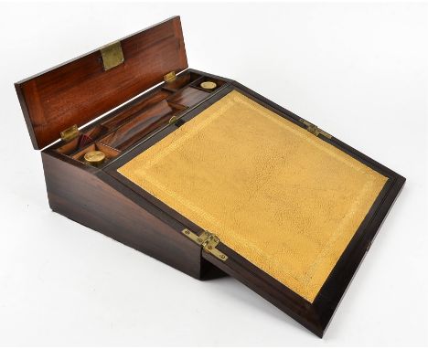 A Victorian rosewood writing slope with brass mountings and inlay, a fitted interior containing two lidded glass bottles, a k