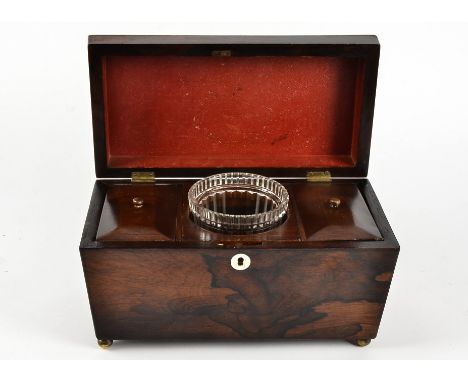 A Victorian rosewood tea caddy, sarcophagus shaped with a mother of pearl escutcheon, the hinged lid opening to reveal two li