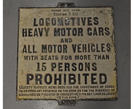 A vintage cast iron road sign, rectangular and stating 'Locomotives, Heavy Motor Cars and all Motor Vehicles with seats for m
