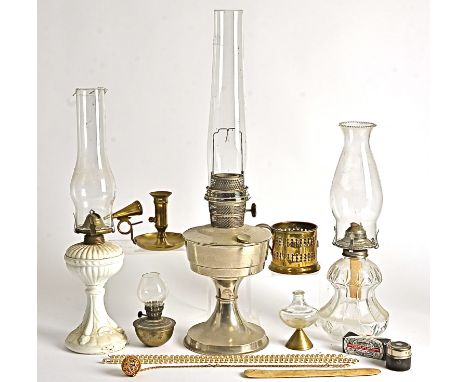 Three 20th Century oil lamps, with ceramic, glass and metal bodies, with shells and chimneys, together with two candleholders