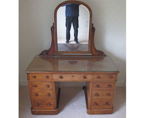 A good quality mahogany Victorian pedestal dressing table/desk,  with arched central mirror with bevelled plate, carved suppo