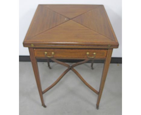 An Edwardian mahogany inlaid envelope card table,  swept cross stretcher, raised on turned tapered supports, finished with ce