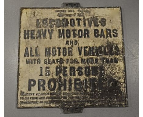 A vintage cast iron road sign, rectangular and stating 'Locomotives, Heavy Motor Cars and all Motor Vehicles with seats for m