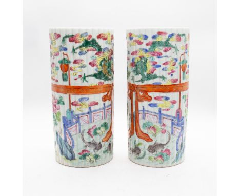 A pair of early 20th Century Chinese porcelain brush pots, white ground simulated bamboo canes painted with central red ribbo