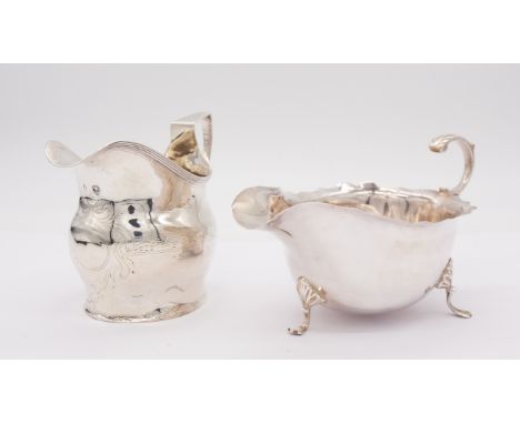 A Georgian silver Helmut shaped milk jug, having engraved design and vacant cartouche to front, hallmarked with George III bu