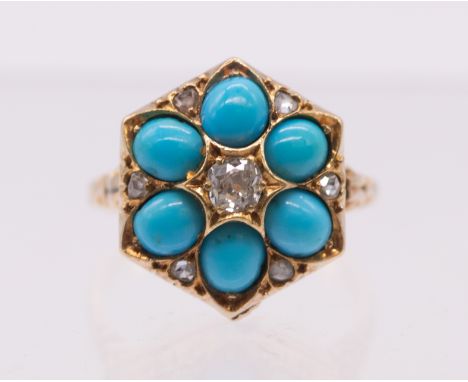 A turquoise and diamond set 18ct gold ring, comprising an  octagonal shaped head set to the centre with an old cushion cut di