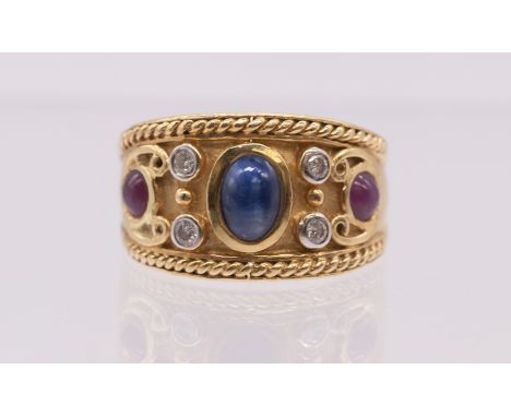 A sapphire, ruby and diamond set 18ct gold ring, comprising a central set oval cabochon sapphire approx 6x4mm, rub over set, 