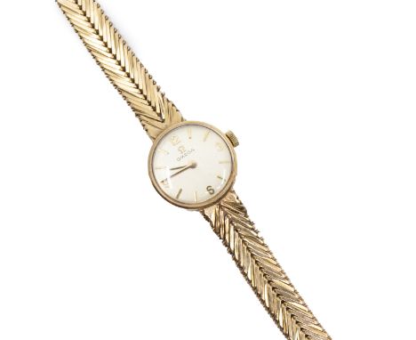 Omega- a ladies vintage 9ct gold Omega wristwatch, comprising a round silvered signed dial, with applied gilt baton and quart