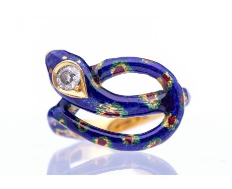 A Victorian diamond enamel 18ct gold serpent ring, comprising a coiled serpent decorated with blue and red enamel details, th