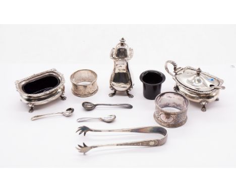 A matching George V silver three piece condiment set consisting of mustard pot with spoon and liner, salt cellar with spoon a