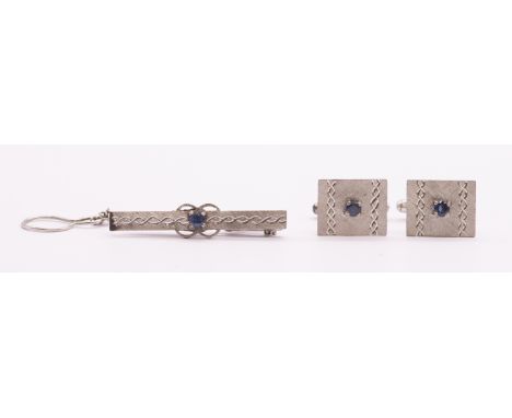 A pair of sapphire set 18ct white gold rectangular cufflinks, set to the centre with a round mixed cut sapphire, measuring ap