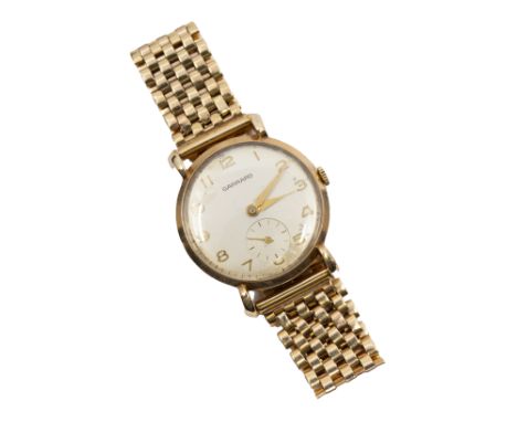 Garrard- a gentleman's 9ct gold vintage wristwatch, comprising a round silvered signed dial with applied gold Arabic indices,