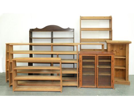 Three similar light wood open bookcases, two others of later date and of pine and another of mahogany-stained wood with glaze
