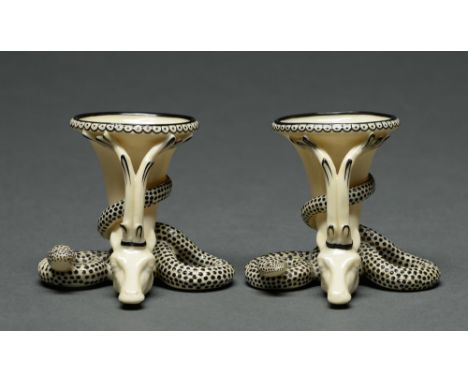 A pair of early Royal Worcester stag and snake rhyton salt cellars, 1862, decorated in black enamel on stained ivory, 75mm h,