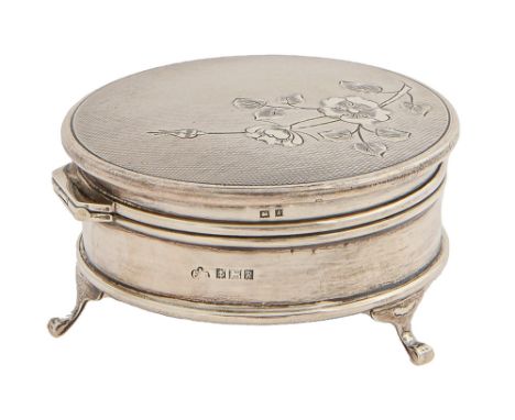 An Elizabeth II round silver trinket box, the engine turned lid engraved with a flower, on three feet, 85mm diam, by Elkingto