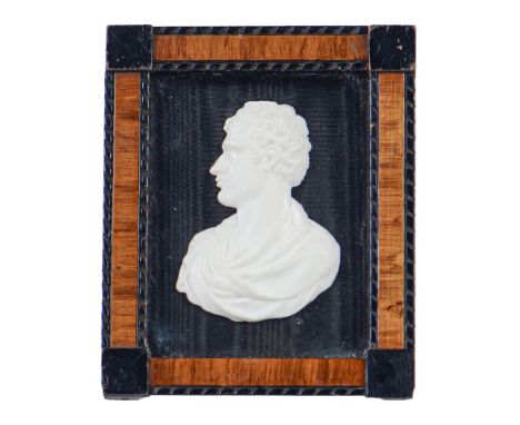 A glass paste bas relief portrait of Lord Byron, 73mm, laid down on black moire silk, in ebonised and walnut frame ConditionA