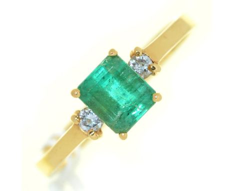 An emerald ring, the step cut emerald flanked by diamonds, in gold marked 18k, 3g, size P ConditionGood condition