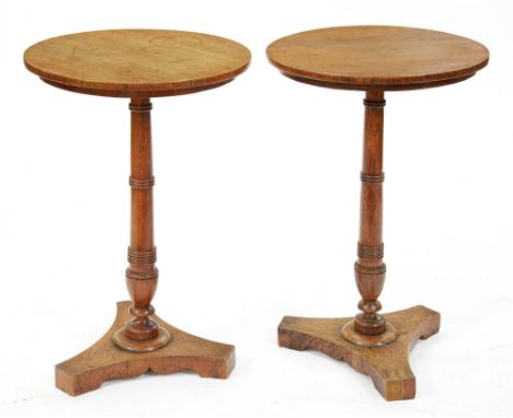 A pair of oak lamp tables, the quarter sawn round top on ring turned pillar with vase knop and tri-form base, 72cm h; 46cm di