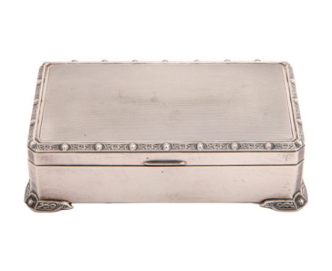 An Elizabeth II silver cigarette box, with applied border of Celtic strapwork, cedar lined, 17cm l, marks rubbed, by Adie Bro