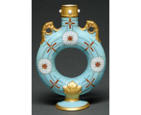 A Royal Worcester aesthetic ring vase, 1874, enamelled with white and red kiku mon on a blue ground, gilt handles, neck and f