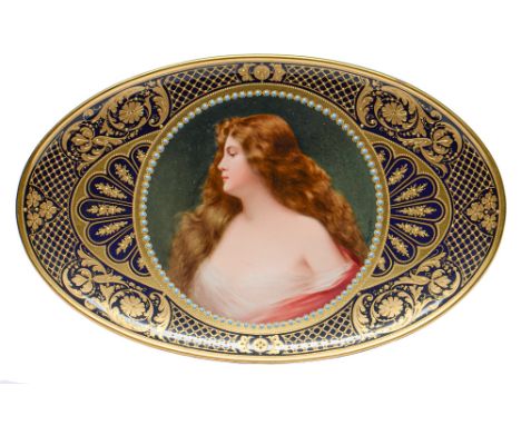 A Berlin oval dish, c1900, finely painted by Wagner, signed, with a bust length portrait of a raven haired beauty in diaphano