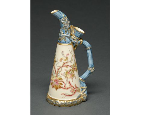 A Royal Worcester bamboo ewer, 1889, decorated with flowers outlined in raised gilding on an ivory ground between moulded blu