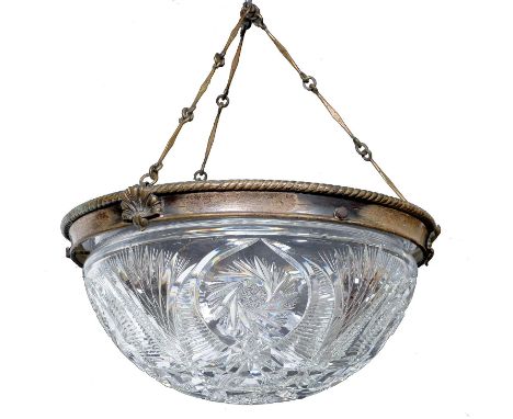 A brilliant cut glass hemispherical hanging lamp bowl, early 20th c, mounted in a silvered brass rope pattern rim and suspend