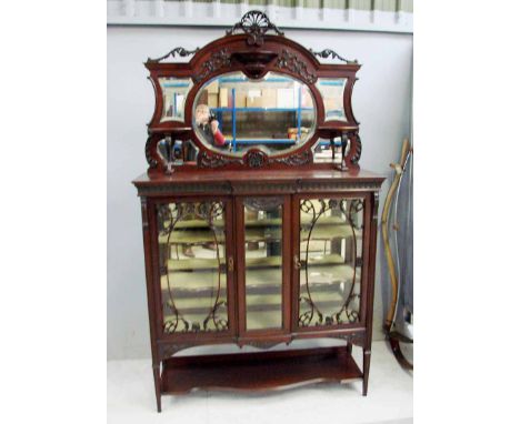 A late Victorian mahogany Display Cabinet, the raised top with pierced shell crest, applied acanthus scrolls and plinths arou