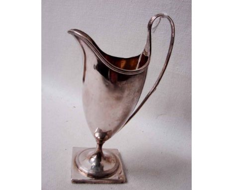 A late 18th century George III silver Jug of helmet shape with reeded loop handle on circular stem with spreading foot fixed 