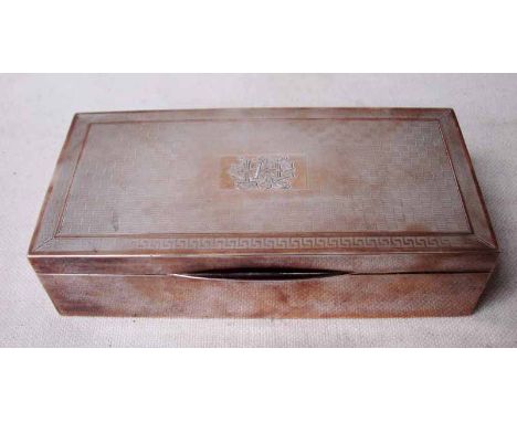 An Art Deco silver Cigarette Box of rectangular form, the hinged lid with Greek Key border around an engine turned panel, cen