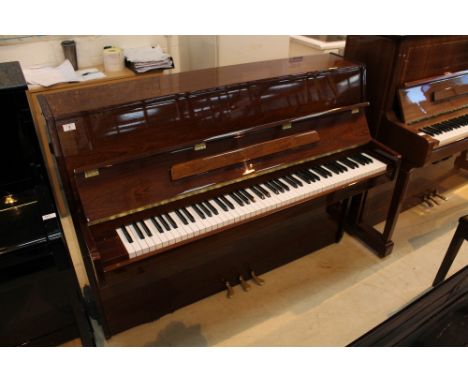 R Schirmer (c1980s) A modern style upright piano in a bright mahogany case; together with a matching stool.