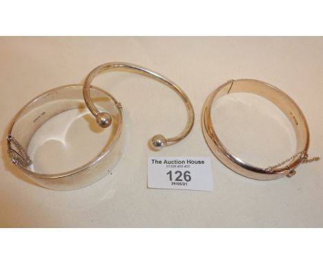 Three hallmarked silver bracelets, one hinged silver gilt, another a torque style bangle