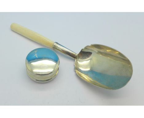 A silver caddy spoon, Birmingham 1876 and a silver pill box, Chester 1907