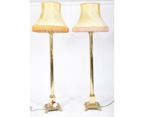 A pair of 20th century gilt metal neoclassical inspired floor standard lamps lights. Each lamp in the shape of a Corinthian c