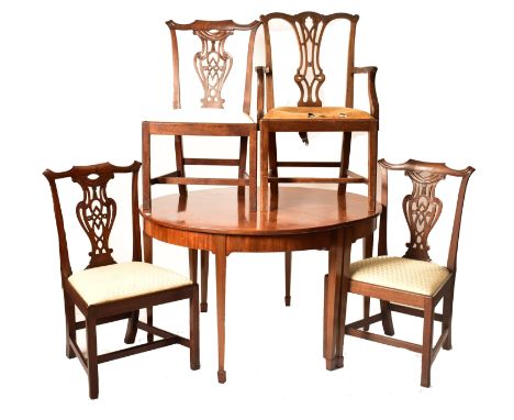 A 19th century George III mahogany extending D-end table with and four chairs. The table having two demi-lune ends raised on 