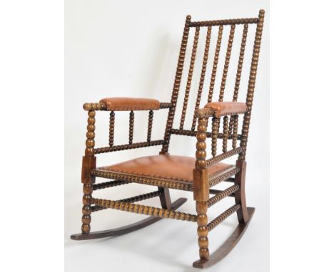 A Victorian late 19th century mahogany William &amp; Mary manner bobbin turned rocking armchair / rocker chair. The chair hav