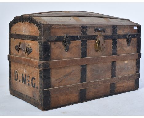 A 19th century dome top wooden and metal bound steamer trunk. The wooden body with ebonised metal strapping and hinges. Dome 