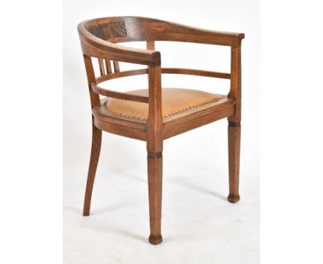 An early 20th century circa 1920s elm wood tub office chair. The chair having a tub shaped back scrolled slat with marquetry 