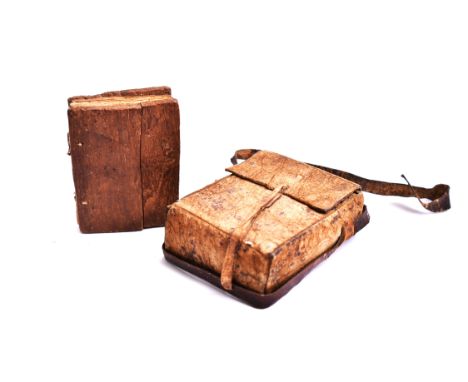 An early 20th century Ethiopian Coptic manuscript prayer book bound in hardwood boards with vellum leaves. Presented in a lea