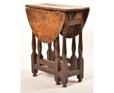 A 17th century George III country oak small proportion drop leaf side table. Raised on turned legs with peripheral stretchers