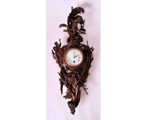 A 19th century carved oak Black Forest wall clock. The clock with carved rococo body with cherub and oars, and fishing nets w