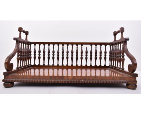 A Victorian 19th century mahogany spindle gallery book tray / trough. Spindle gallery sides with twin handles over a panel ba